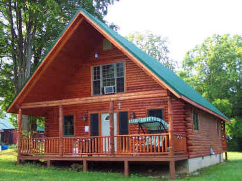 Cozy log cabin with a green metal roof