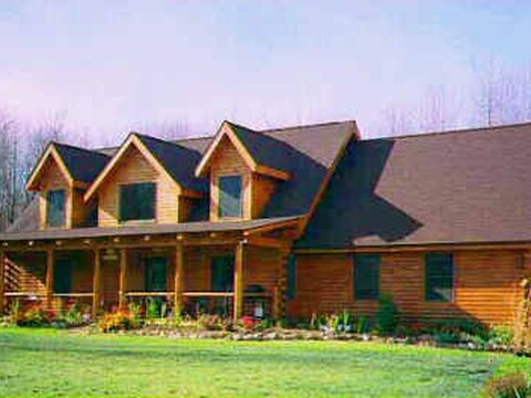 Log home with triple dormers and a wraparound porch