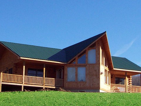 Large custom log home at dusk