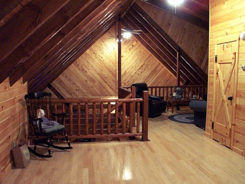 Log loft railing overlooking the living room below
